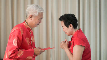 Asian senior Chinese new year red envelop happy festivalの写真素材
