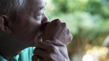 Asian senior man worry lost expression close up shotの写真素材