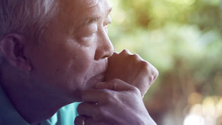 Asian senior man worry lost expression close up shotの写真素材