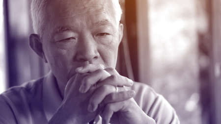 Asian senior man worry stress thinking about lifeの写真素材