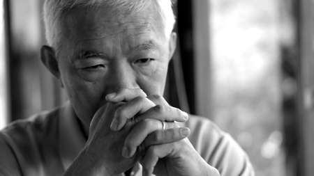 Asian senior man worry stress thinking about lifeの写真素材
