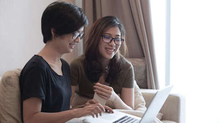 Mixed race Asian girls using computer for businessの写真素材