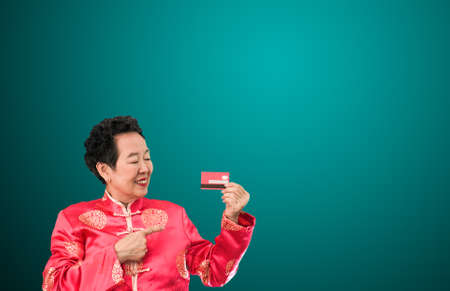 Asian senior woman shopping credit card Chinese New Year discount dealの写真素材