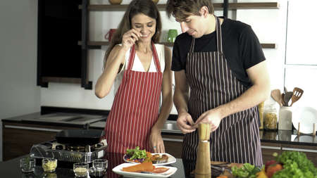 Cuacasian couple quality time cooking togetherの写真素材