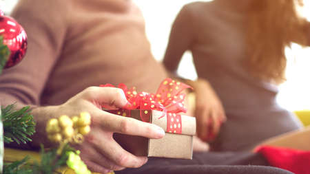 Surprise early Christmas gift hand holding present boxの写真素材