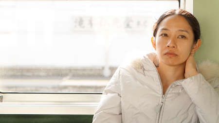 Asian girl worry in morning train workの写真素材