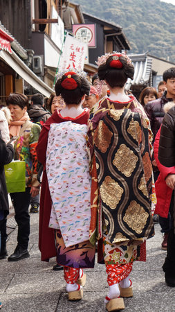 Kyoto, Japan - March 2015: Beautiful Japanese Geisha with beautiful kimono walking along the street in Kyoto Japanのeditorial素材