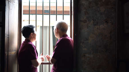Asian old couple worry discuss serious life problem in classic Asia buildingの写真素材