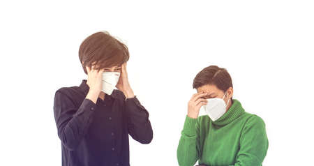 Two Asian friends wearing mask stress angry and annoy with Covid-19 and pollution situation too many problemsの写真素材