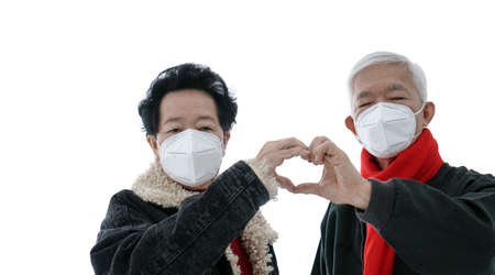 Asian elder senior couple encourage and support to win fight Coronavirus while wearing mask protectionの写真素材