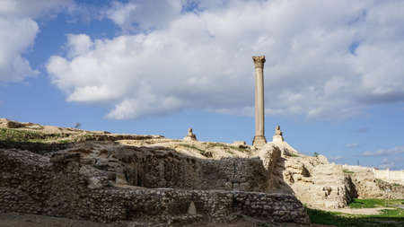 Alexandria Egypt Pompey's Pillar from far view with cloudy blue sky