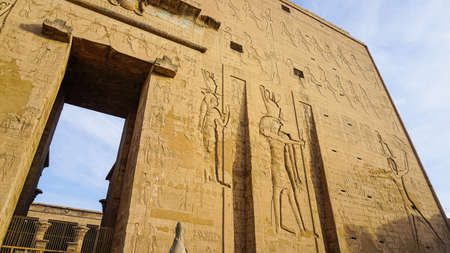 Entrance gate of Edfu temple of Horus majestic beautiful landmark with ancient blue paint on wallの写真素材