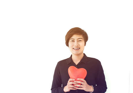 Asian sporty beaces woman short hair holding red heart abstract  love balloon white background copy spaceの写真素材