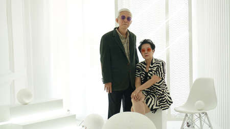 Asian senior elder hipster couple wearing stylish fashion winter dress white background with copy...