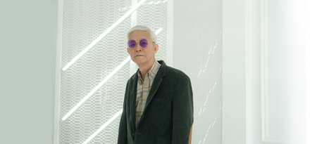 Asian senior man model in fashion and sunglasses dress up white backgroundの写真素材