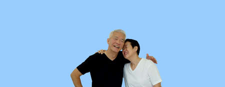 Asian senior couple hugging studio shot banner with copu spaceの写真素材