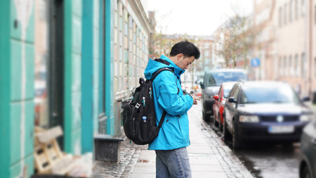 Asian man backpack travel to Europe lost searching street on internet mobileの写真素材