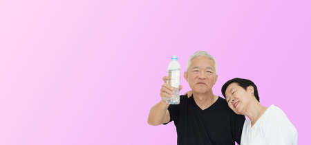 Asian senior couple promote drinking water stay hydrate for healthy lifestyleの写真素材