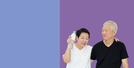 Asian senior couple promote drinking water stay hydrate for healthy lifestyleの写真素材