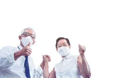 Asian senior elderly couple encourage business planning on fight go through pandemicの写真素材