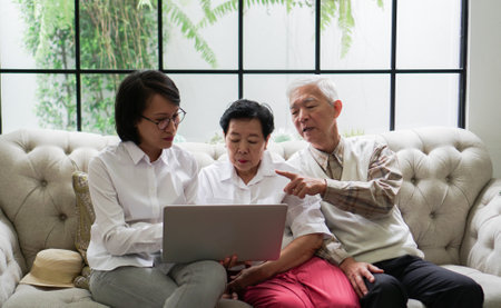 Asian advisor consultant to senior showing data through laptop discuss on plan investment and healthcareの写真素材