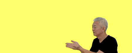 Asian senior elder retired man show display gesture for copy space on blank space for advertising backgroundの写真素材