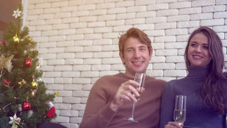 Caucasian couple celebrating season holiday with champagne drinksの写真素材