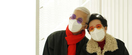 Asian senior elderly couple worry depress about Covid-19 pandemic Winter with Omicron never ending pandemicの写真素材