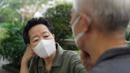Asian elderly couple with mask protection bored with pandemic losing income and retirement lifeの写真素材