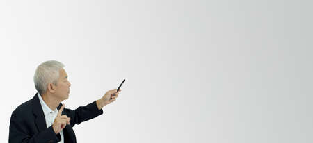 Serious Asian senior businessman executive manager teaching pointing over copy spaceの写真素材