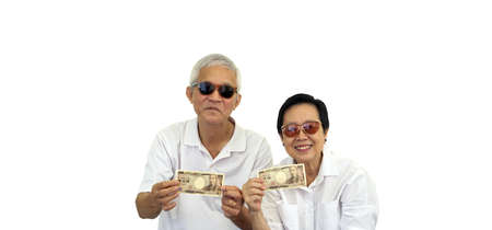 Asian senior couple holding cash money investment profit retirement benefit finance
