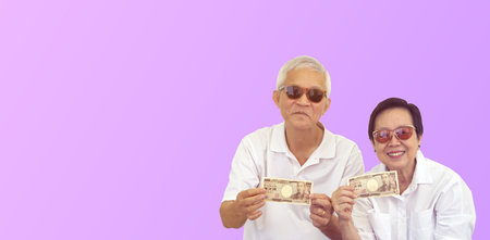 Asian senior couple holding cash money investment profit retirement benefit finance