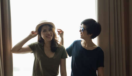 two Asian women casual summer fashion relax and fun together at homeの写真素材