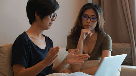 Two entrepreneur Asian woman glasses working from anywhere with laptop computerの写真素材