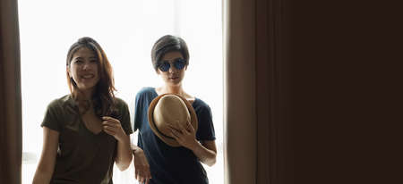 two Asian women casual summer fashion relax and fun together at homeの写真素材