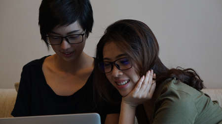 Two entrepreneur Asian woman glasses working from anywhere with laptop computerの写真素材