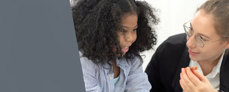 Creative class in diversity school Caucasian teacher with African kid having fun learning critical thinking global citizen education conceptualの写真素材