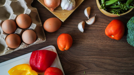 Flay lay food cooking vegetable broccoli egg pepper pea garlic background on wood texture text copy spaceの写真素材