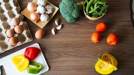 Flay lay food cooking vegetable broccoli egg pepper pea garlic background on wood texture text copy spaceの写真素材