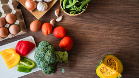 Flay lay food cooking vegetable broccoli egg pepper pea garlic background on wood texture text copy spaceの写真素材