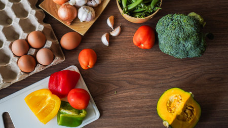 Flay lay food cooking vegetable broccoli egg pepper pea garlic background on wood texture text copy spaceの写真素材