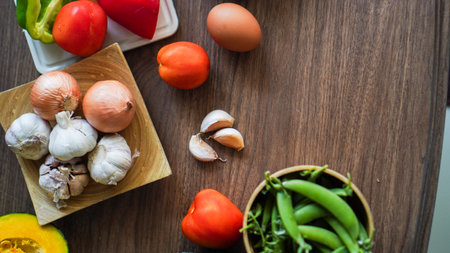 Flay lay food cooking vegetable broccoli egg pepper pea garlic background on wood texture text copy spaceの写真素材