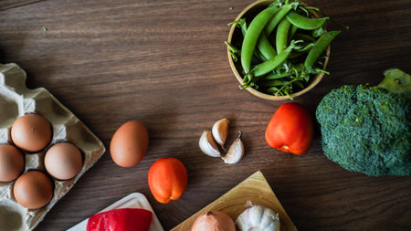 Flay lay food cooking vegetable broccoli egg pepper pea garlic background on wood texture text copy spaceの写真素材