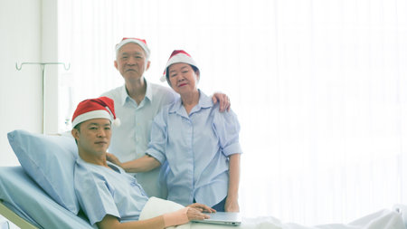 Asian family celebrating Christmas and New Year in hospital kid admit recovery good family relationship toetherの写真素材
