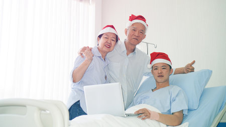 Asian family celebrating Christmas and New Year in hospital kid admit recovery good family relationship toetherの写真素材