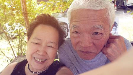 Asian senior elder couple taking selfie together fun retire trip together lifestyleの写真素材