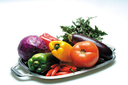 Metal plate with vegetables on white backgroundの写真素材