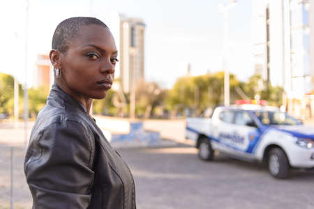 Black woman with short hair on an urban background