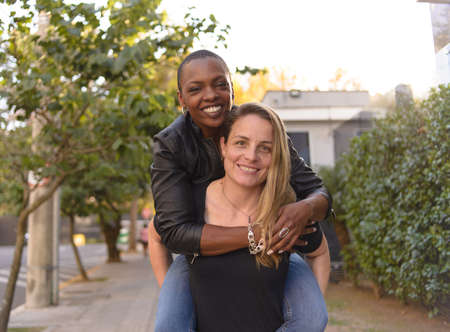 Romantic and fun portrait of a young lgbt couple on an urban backgroundの写真素材