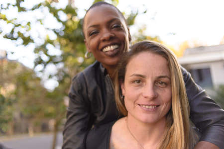 Romantic and fun portrait of a young lgbt couple on an urban backgroundの写真素材
